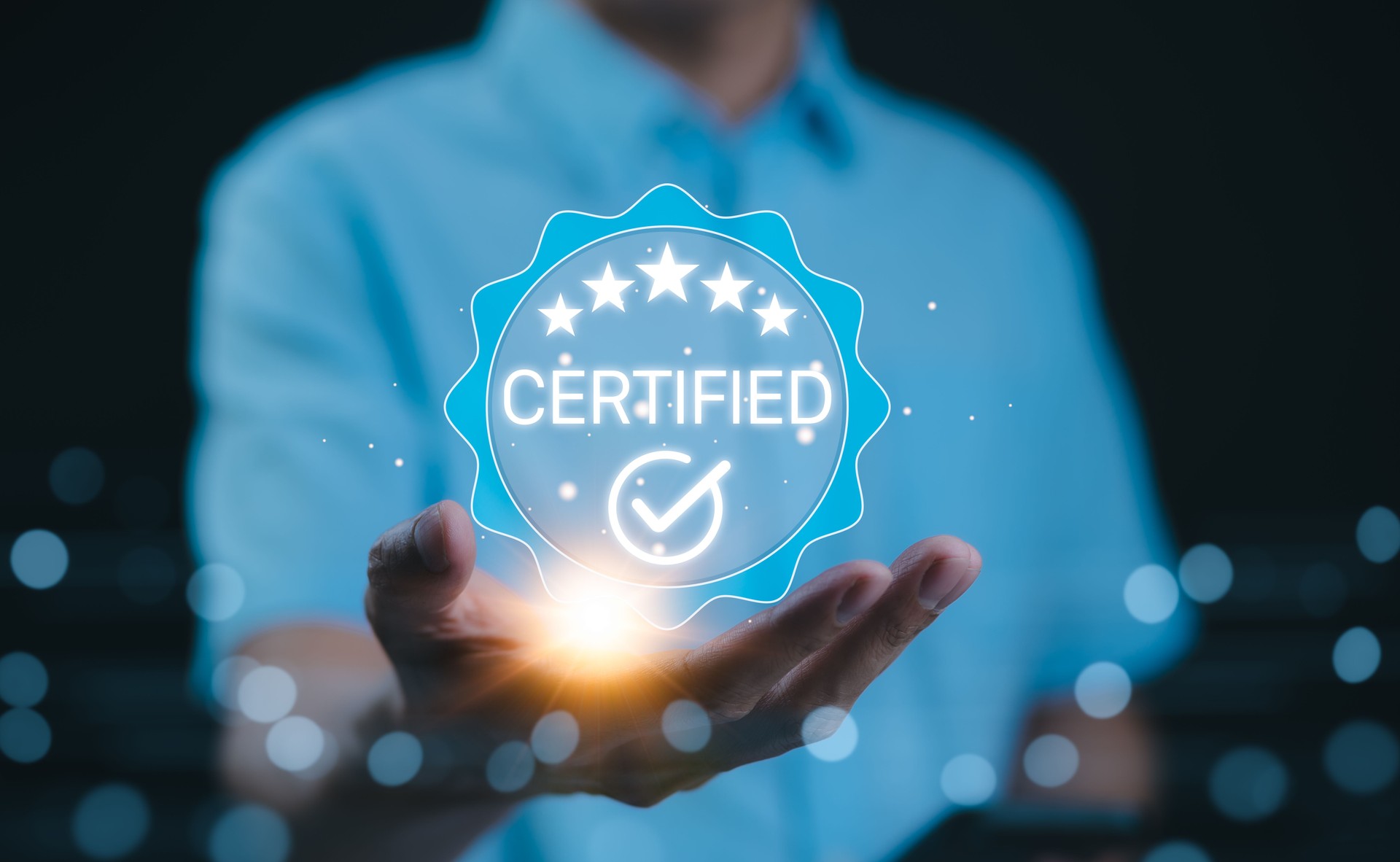Certified concept. A person holds a glowing holographic badge displaying the word "Certified" with a checkmark and stars, symbolizing quality assurance, accreditation, and validation. ISO Certified,